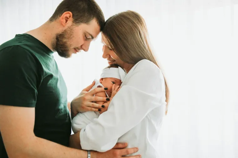 Parents smiling at their newborn