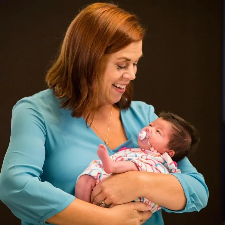 Tonya Sakowicz holding a newborn