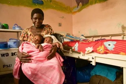 Apio and Acen With mum Esther in Ugandan hospital